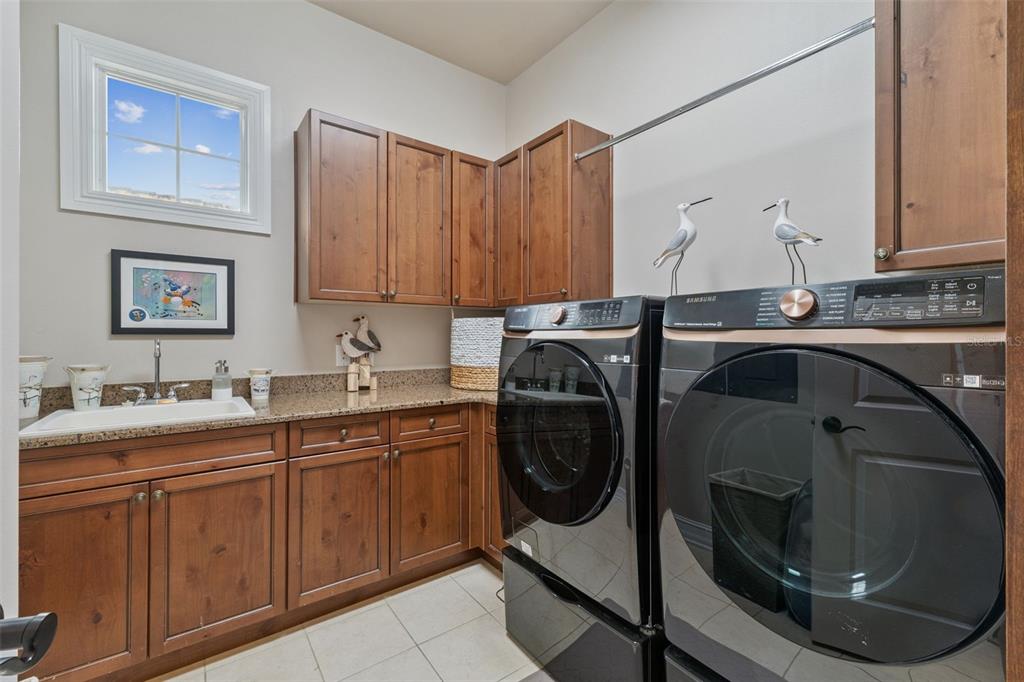 1172 Castle Pines Court Reunion, FL 34747 - Photo 38 of 65 a utility room with a sink a washer and dryer