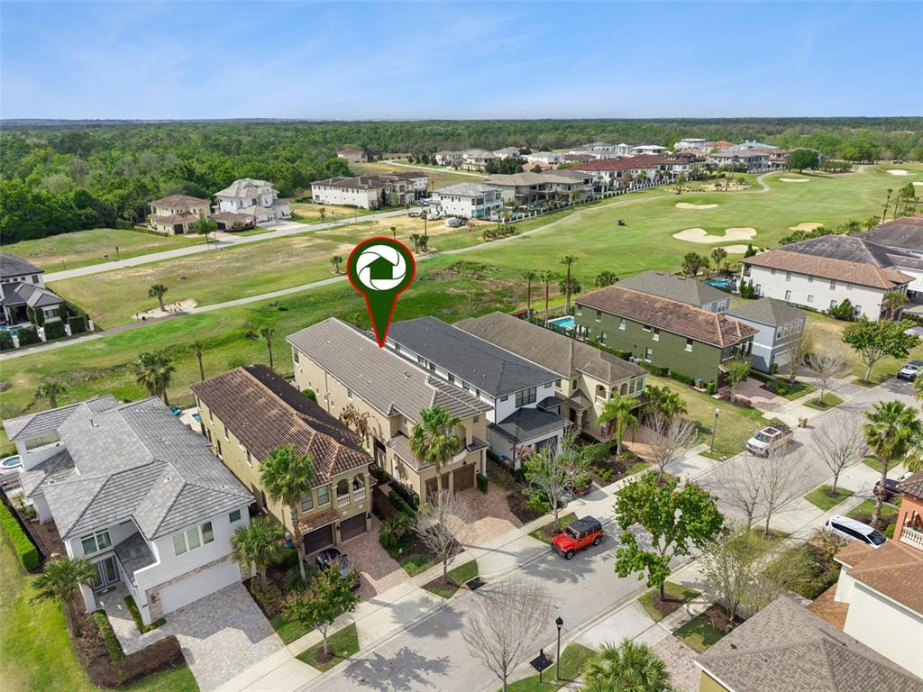 1172 Castle Pines Court Reunion, FL 34747 - Photo 51 of 65 an aerial view of a city with lots of residential buildings and mountain view in back