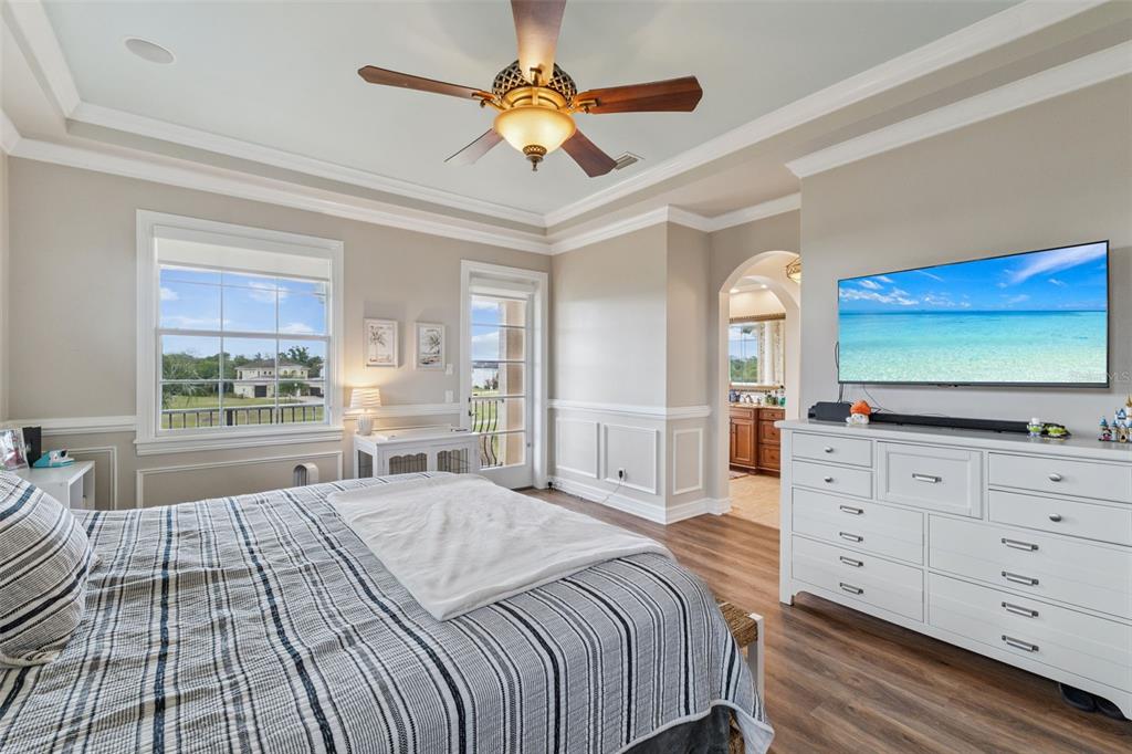 1172 Castle Pines Court Reunion, FL 34747 - Photo 7 of 65 a bedroom with a large bed and a flat tv screen on dresser