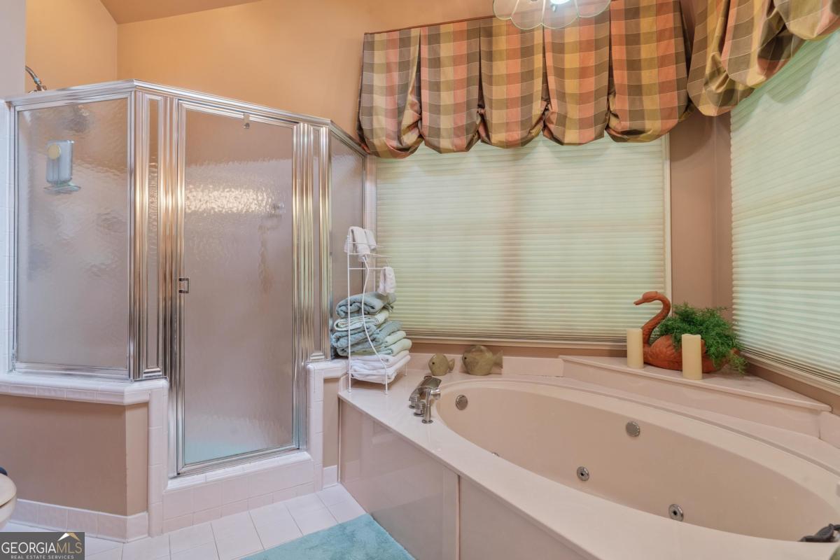 1031 Old Still Road Greensboro, GA 30642 - Photo 37 of 73 a bathroom with a bathtub and a shower