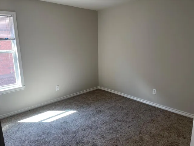 an empty room with a empty space and windows