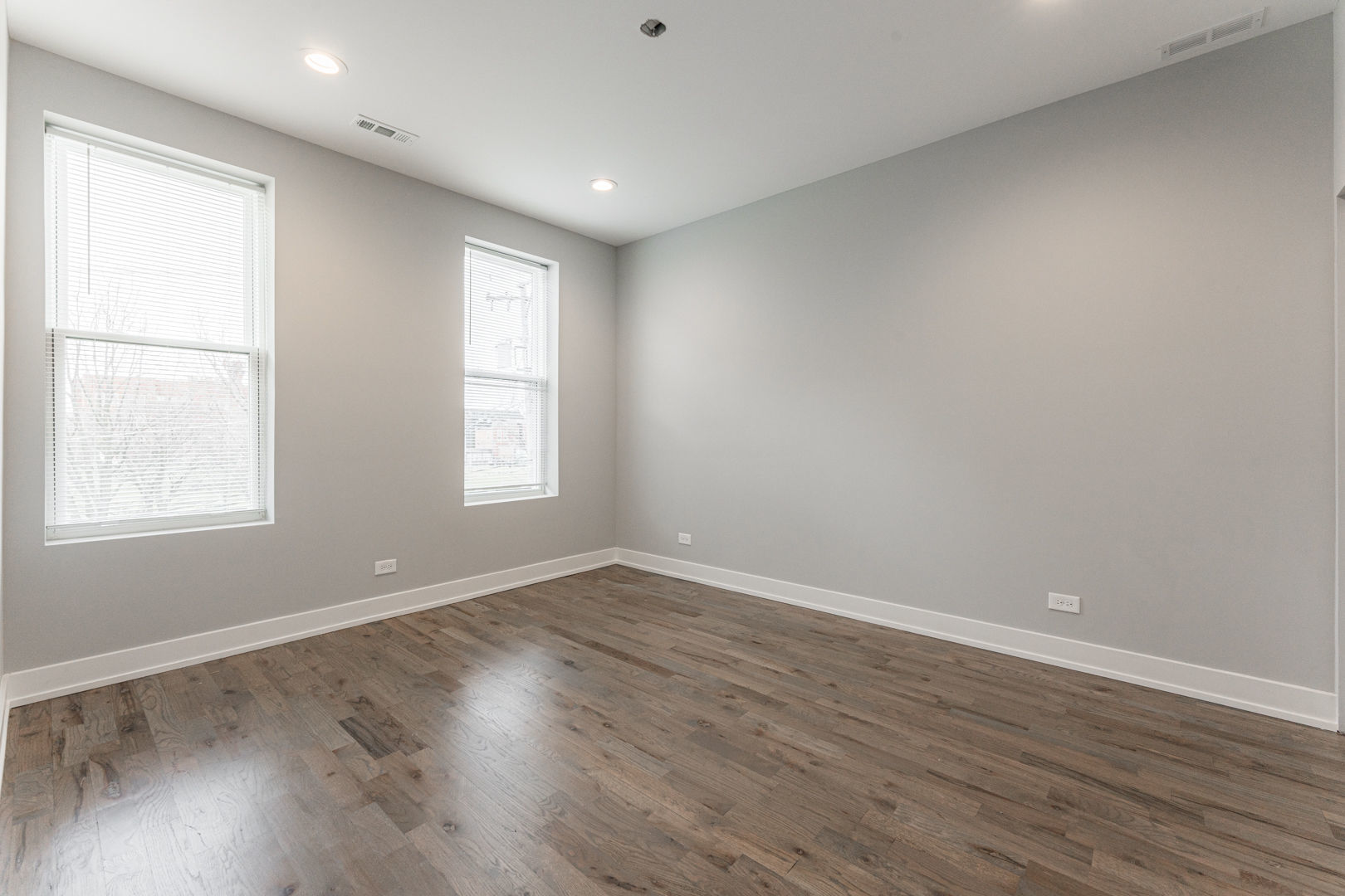 926 West 32nd Place, Unit 2F Chicago, IL 60608 - Photo 6 of 18 a view of an empty room with wooden floor and a window