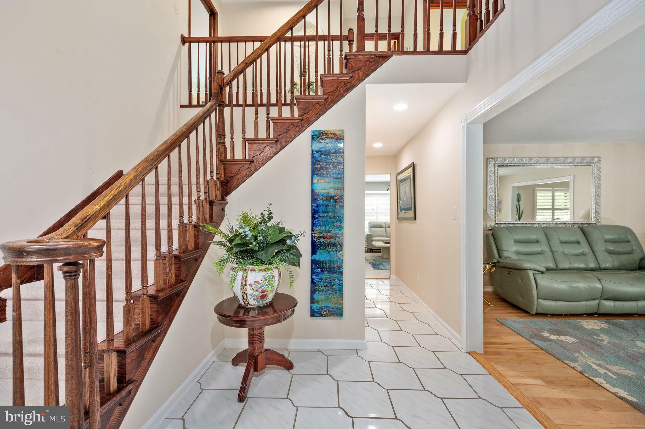 11105 Waddell Road Bumpass, VA 23024 - Photo 16 of 76 a view of staircase with lots of frames on wall and a potted plant