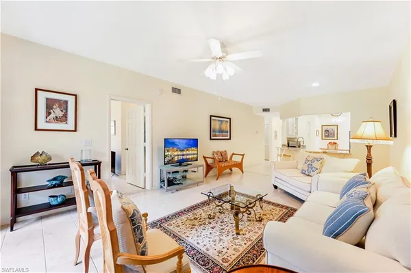 a living room with furniture a rug and a chandelier