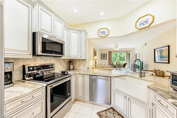 a kitchen with a sink stove and microwave