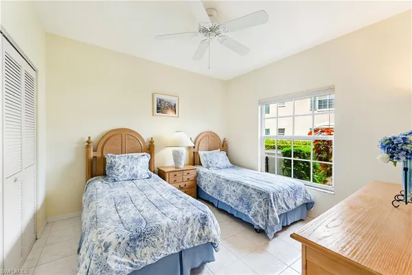 a bedroom with two beds and a window