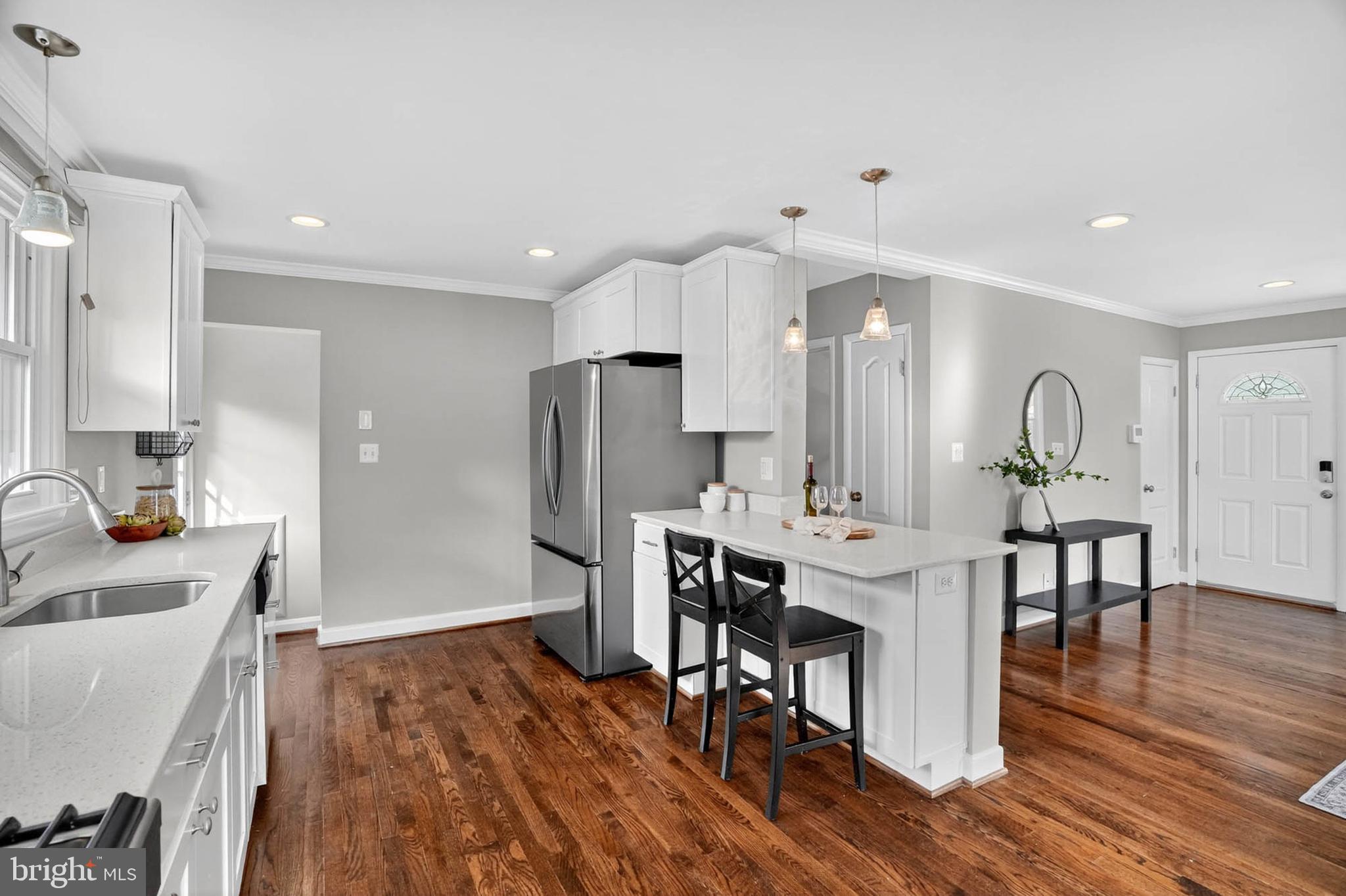 1920 Drummond Road Catonsville, MD 21228 - Photo 12 of 45 a kitchen with stainless steel appliances a dining table chairs and wooden floor