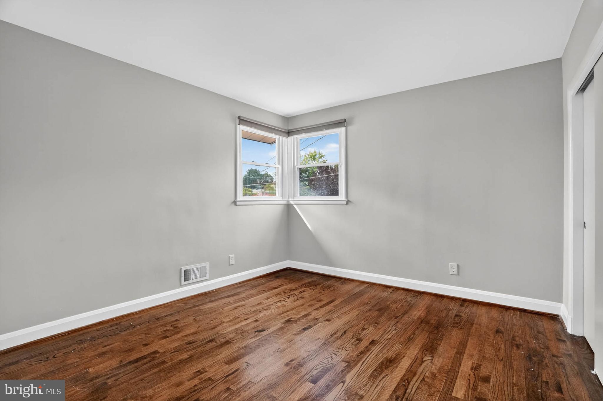 1920 Drummond Road Catonsville, MD 21228 - Photo 18 of 45 an empty room with wooden floor and windows