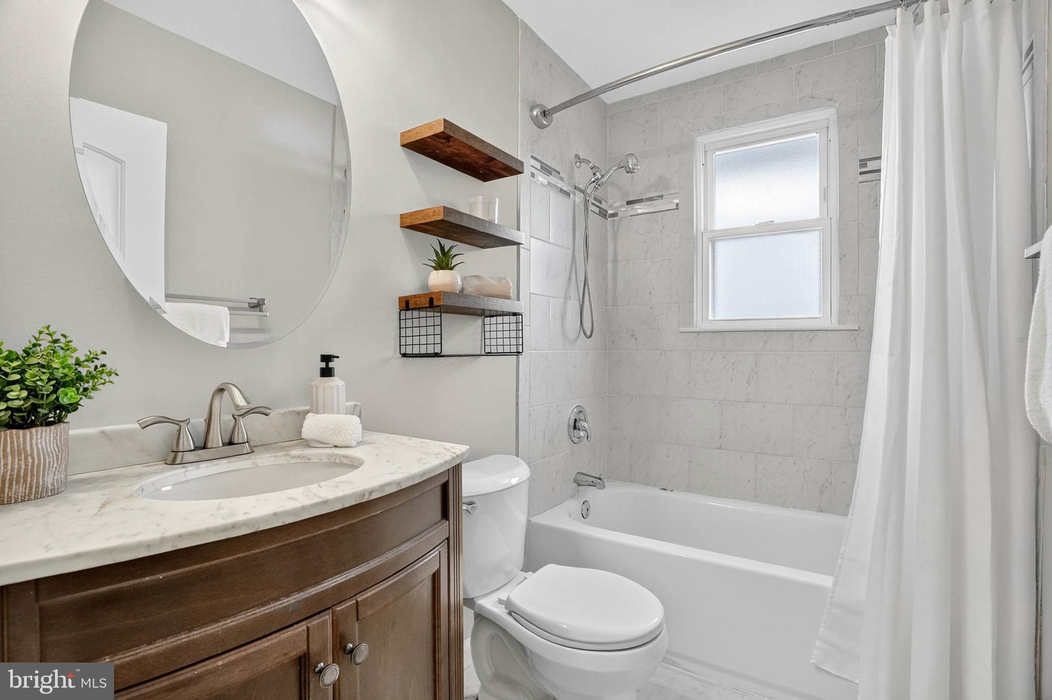 1920 Drummond Road Catonsville, MD 21228 - Photo 22 of 45 a bathroom with a granite countertop sink a toilet and shower