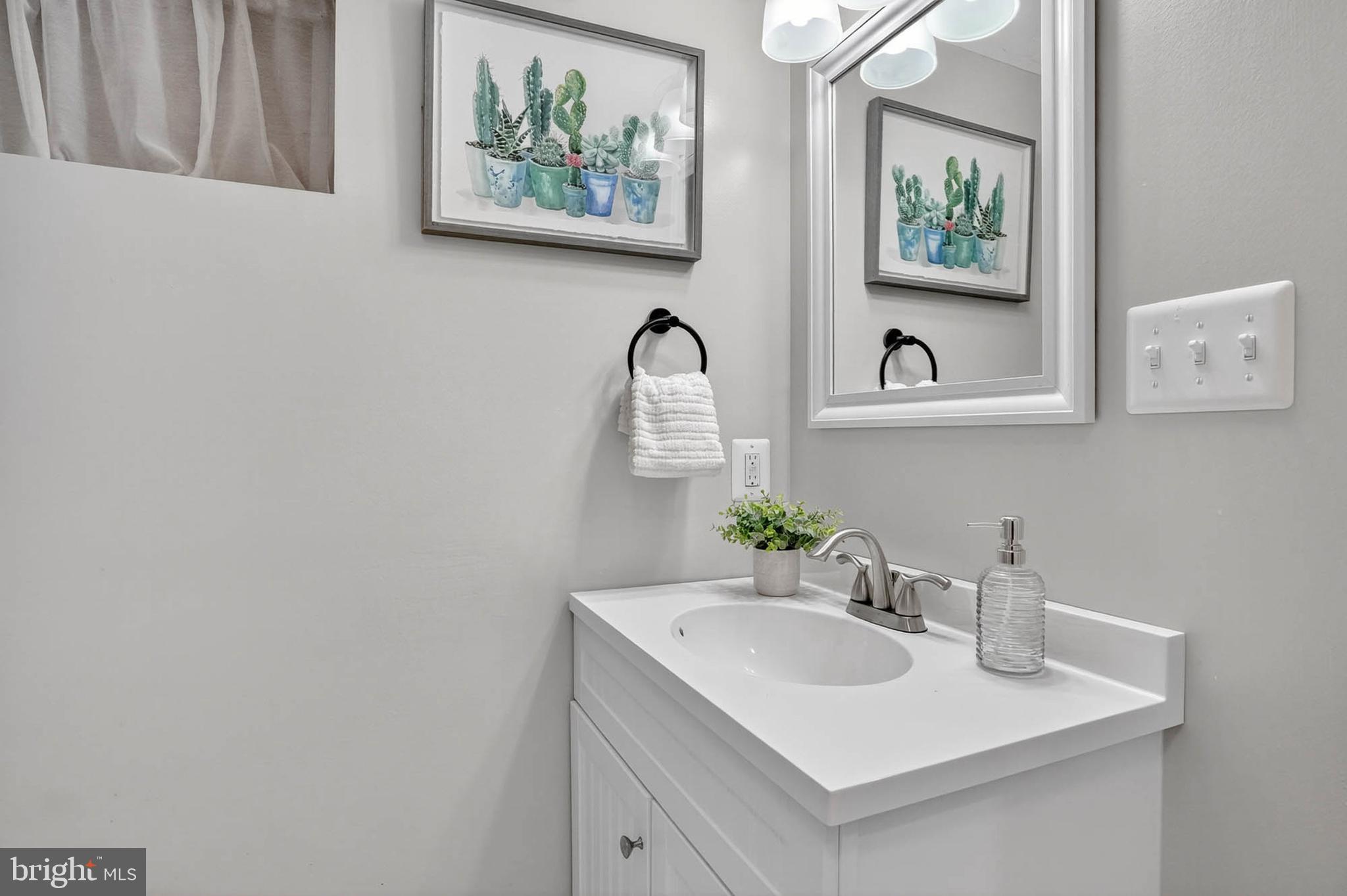 1920 Drummond Road Catonsville, MD 21228 - Photo 33 of 45 a bathroom with a sink and a mirror