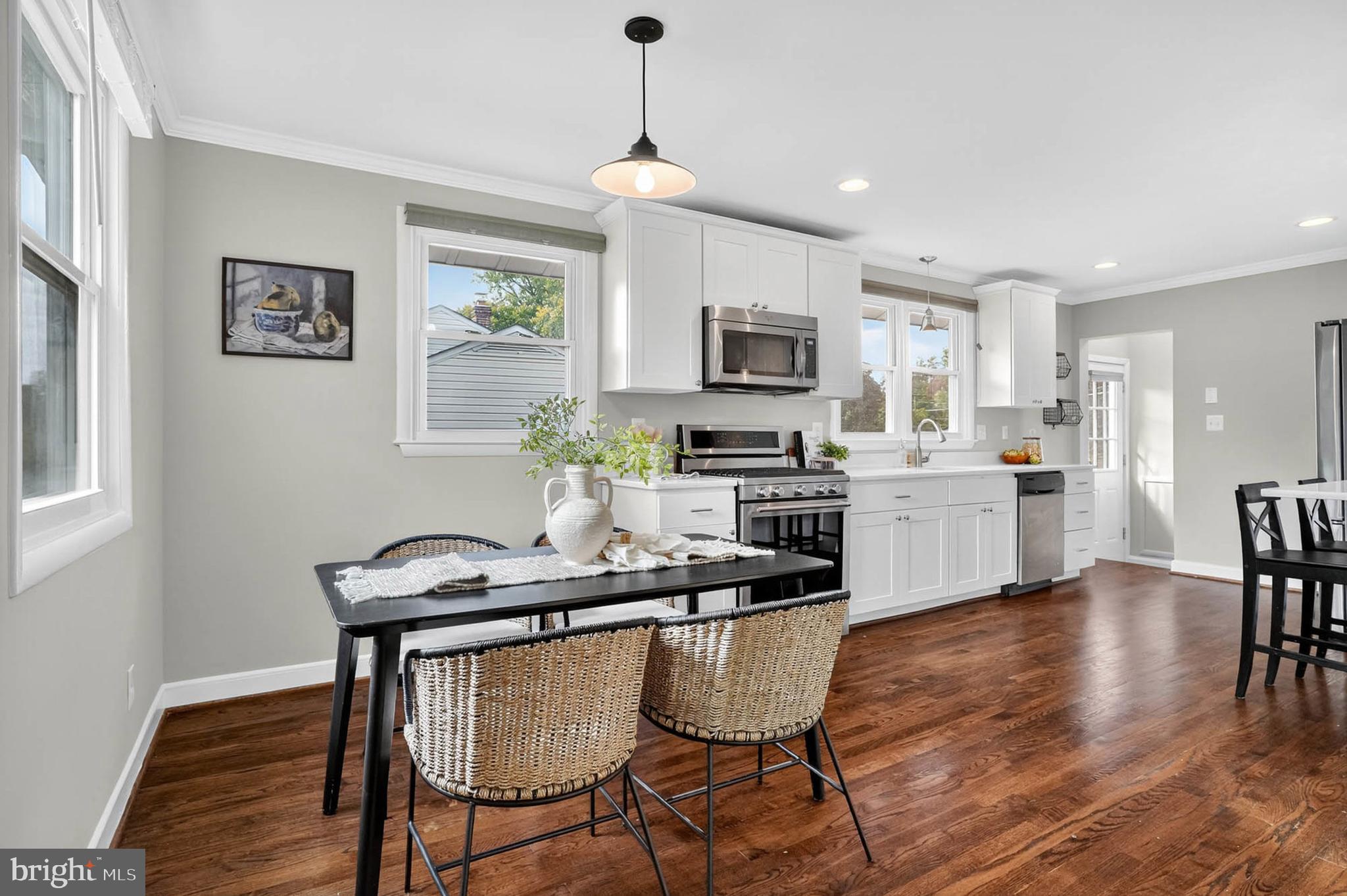 1920 Drummond Road Catonsville, MD 21228 - Photo 9 of 45 a kitchen with sink cabinets dining table and chairs