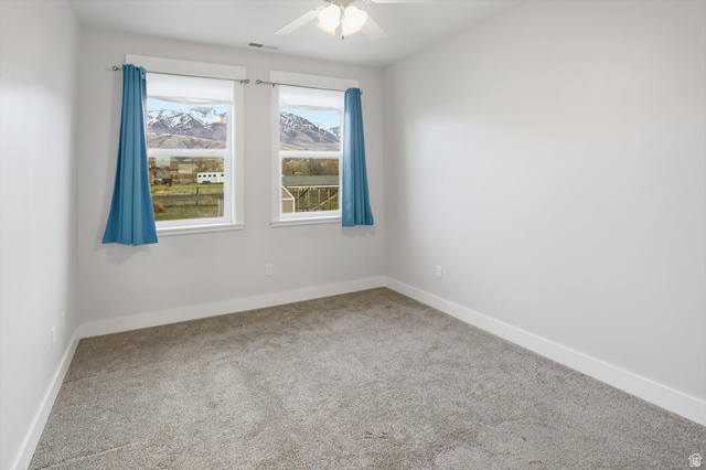 1009 High Creek Road Cove, UT 84320 - Photo 59 of 79 ADU Bedroom featuring a ceiling fan and a mountain view
