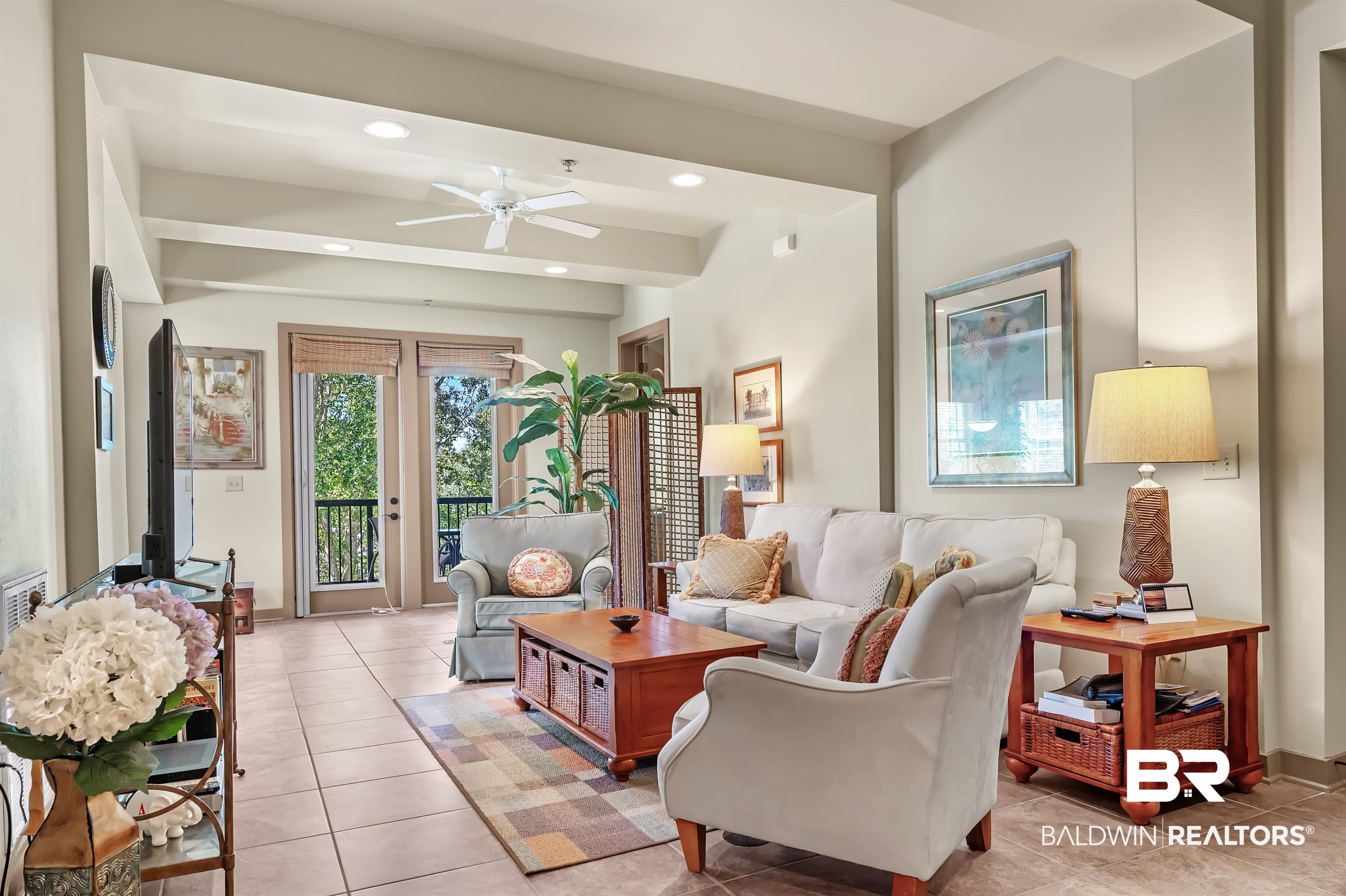 1430 Regency Road, Unit A301 Gulf Shores, AL 36542 - Photo 7 of 47 Tiled living room with ceiling fan and beam ceiling