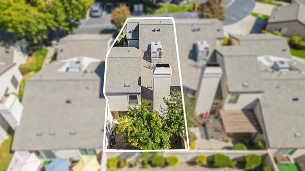 an aerial view of residential houses with outdoor space