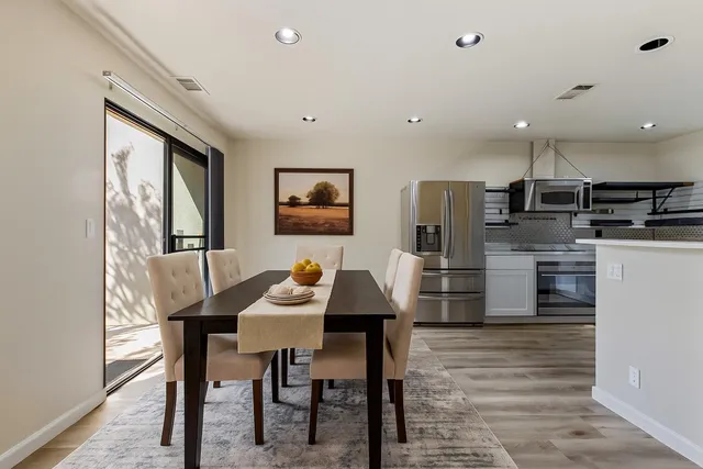 a view of a dining room with furniture and wooden floor