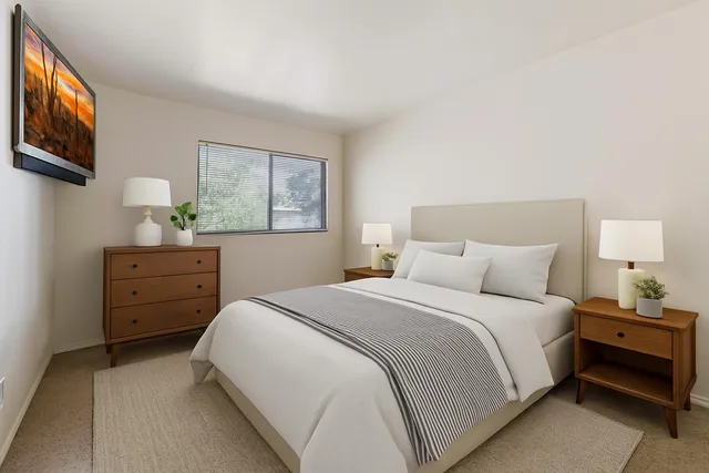 a bedroom with a bed and a window