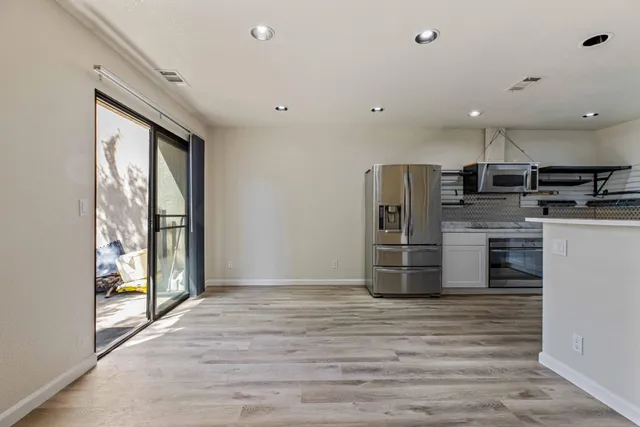 a kitchen with stainless steel appliances a refrigerator and a stove top oven
