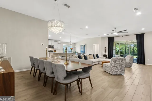 a kitchen with counter space dining table and stainless steel appliances