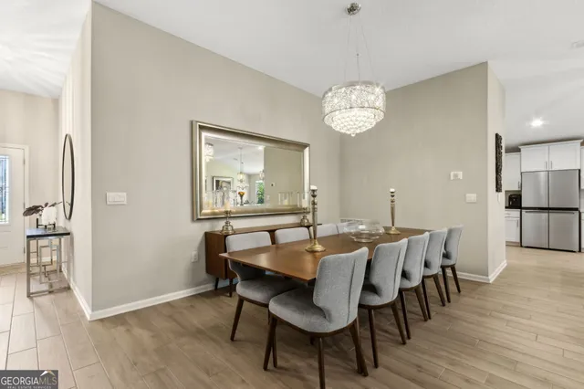 a kitchen with stainless steel appliances a white stove top oven and white cabinets