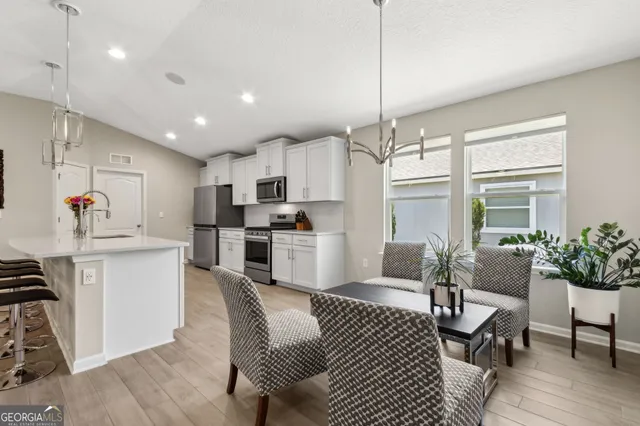 a view of a dining room with furniture wooden floor and chandelier