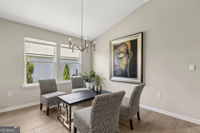 a spacious bedroom with a bed and glass door