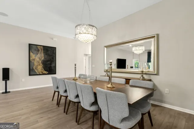 a bedroom with a bed television and a large window