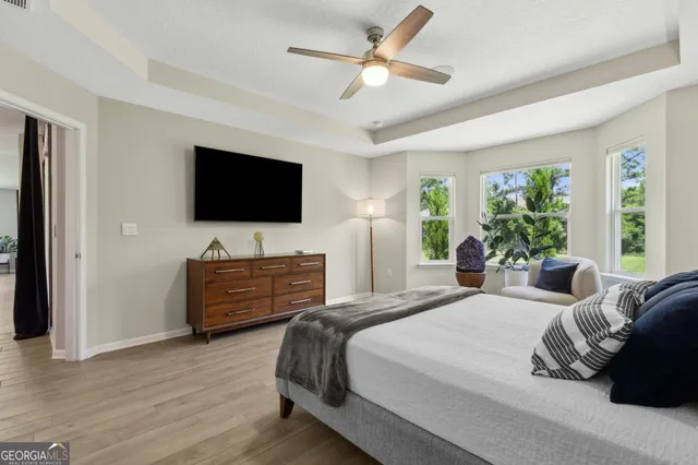 a bathroom with a tub a sink and a mirror