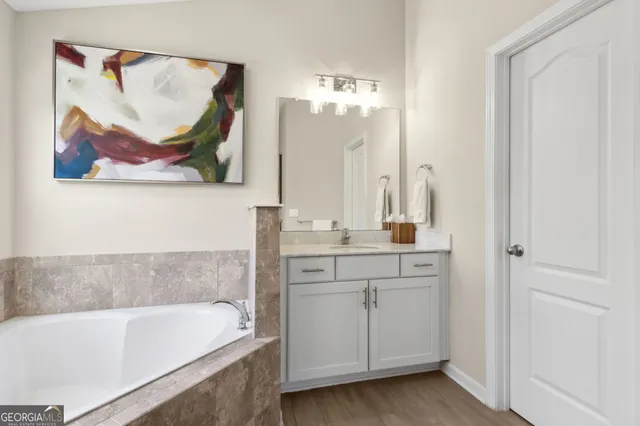 a bedroom with a bed a window and painting on the wall