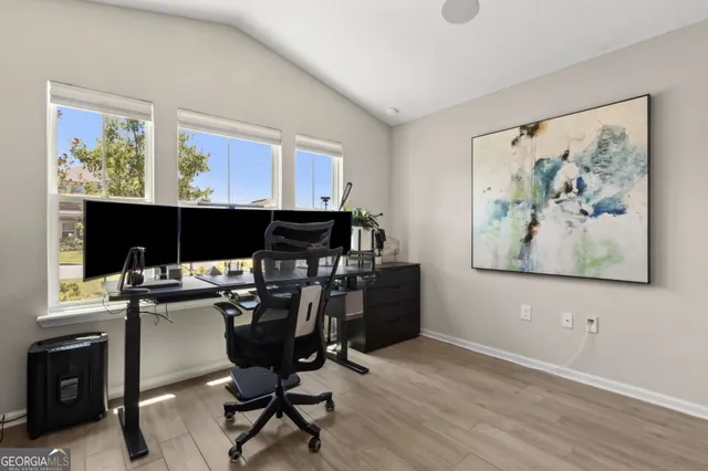 a living room with furniture a large window and a chandelier