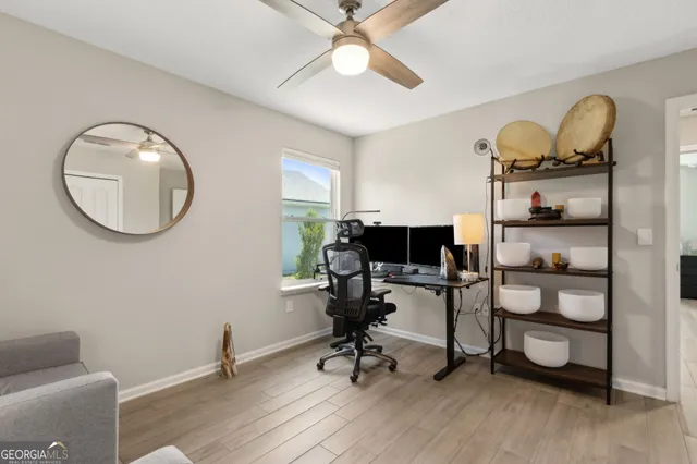 a view of a workspace with furniture and wooden floor