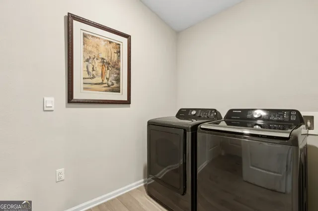 a living room with furniture a chandelier and a large window