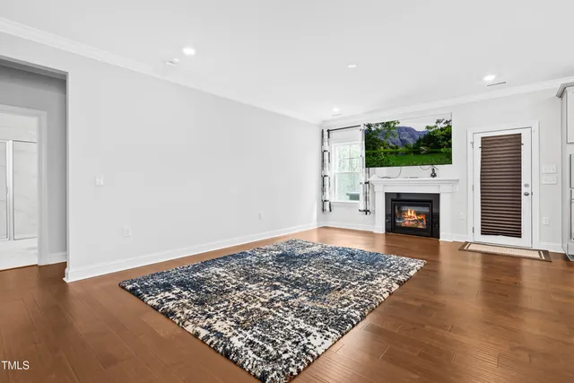 a living room with a fireplace and a flat screen tv