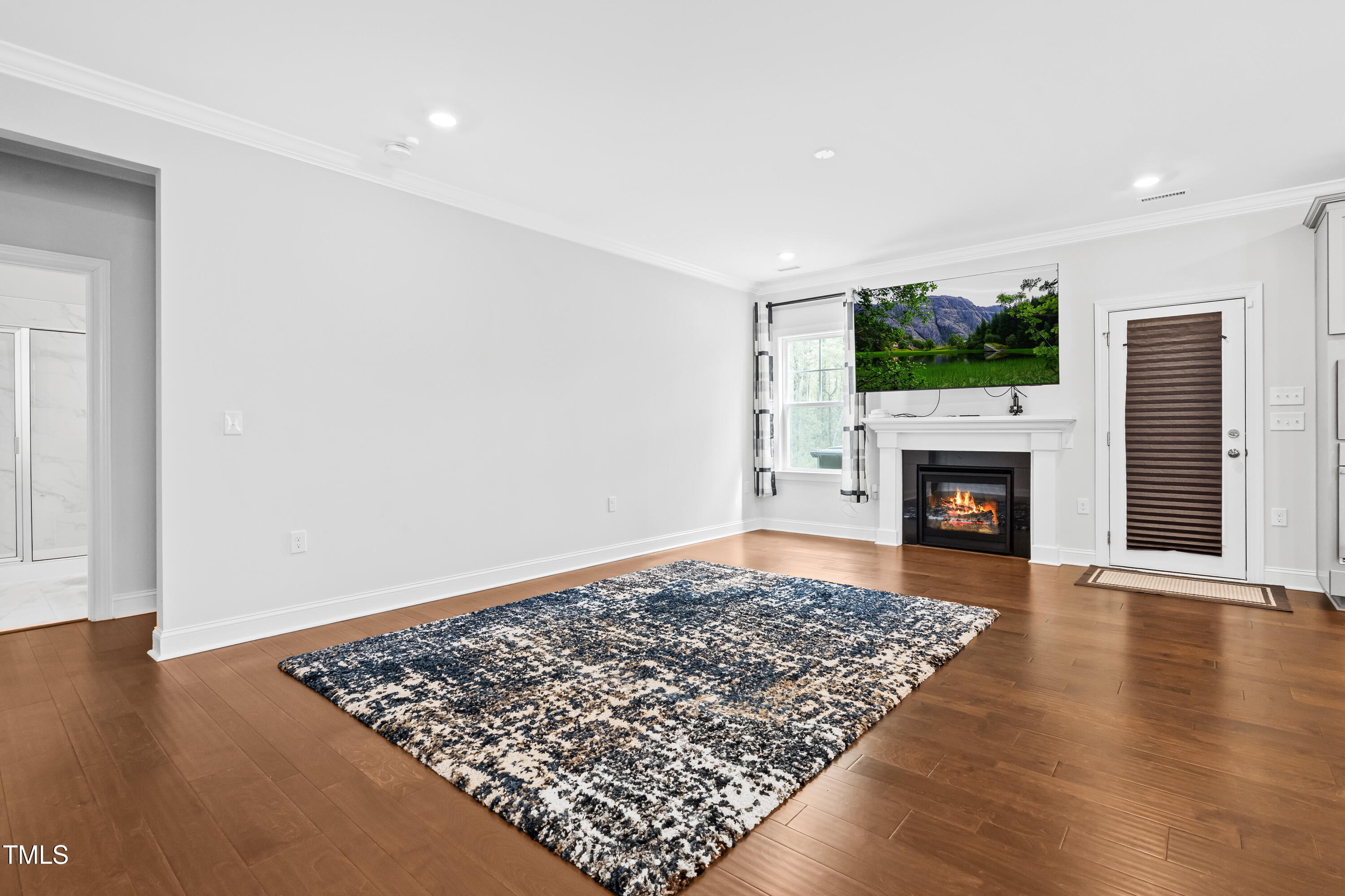 270 Trailing Blf Way Garner, NC 27529 - Photo 15 of 41 an empty room with wooden floor and fireplace