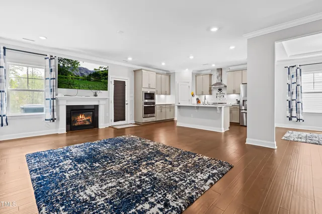 a living room with kitchen island furniture and a wooden floor