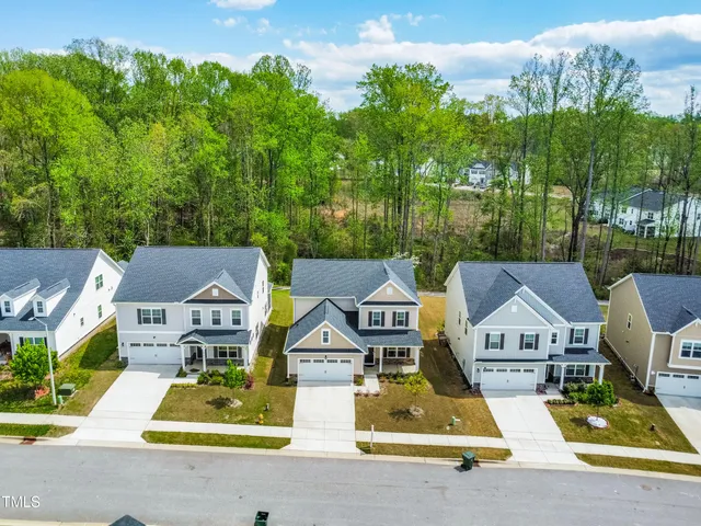 a aerial view of a house with swimming pool and garden