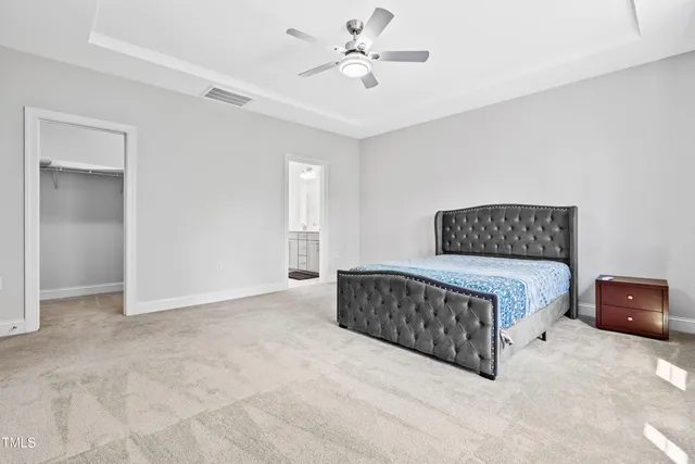 a bedroom with a bed and a ceiling fan