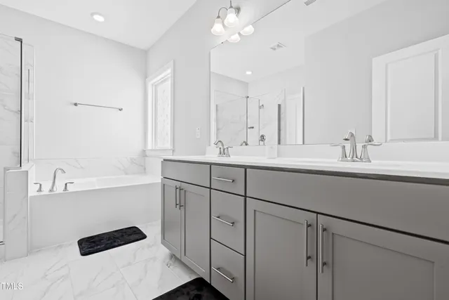 a bathroom with a bathtub and a shower