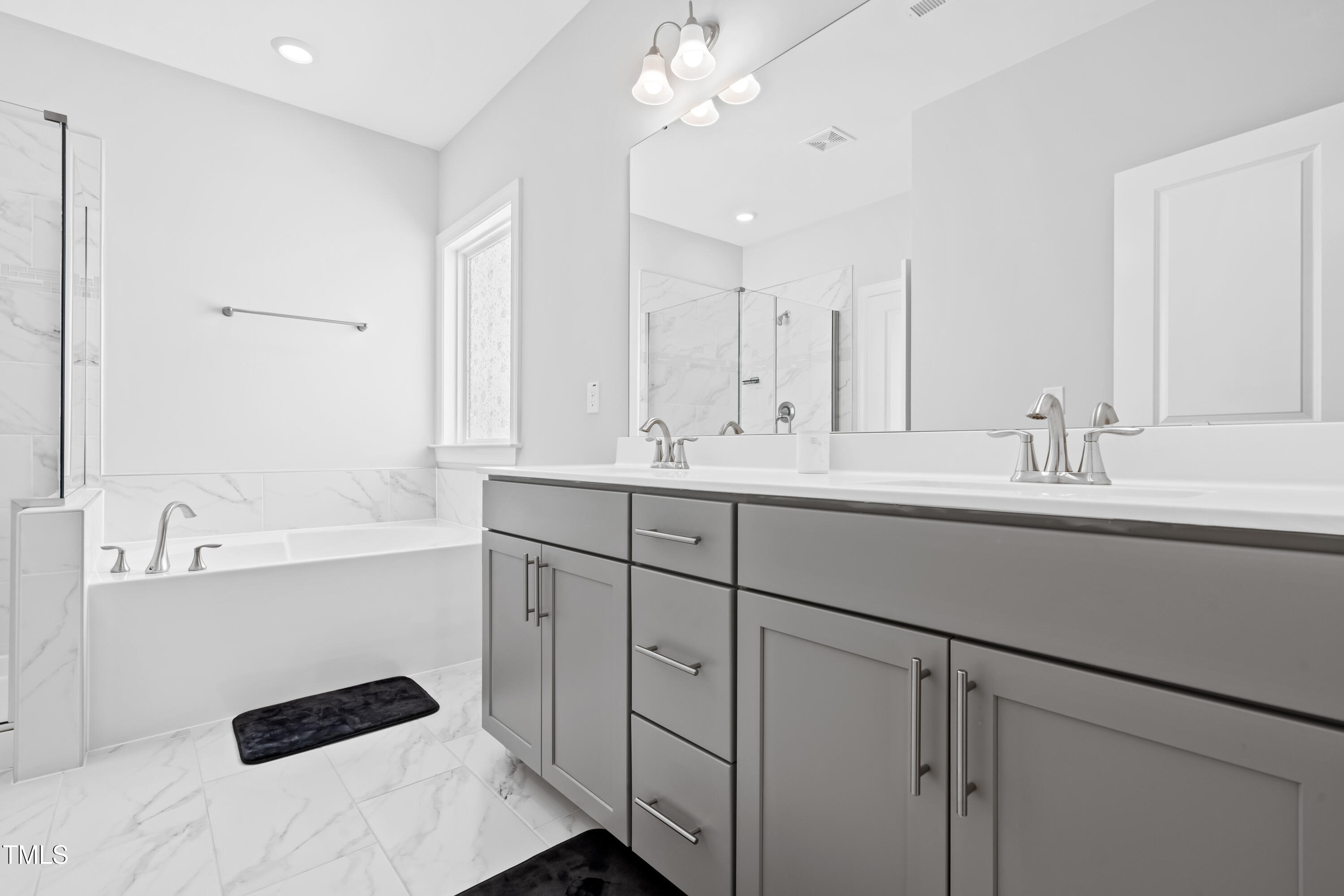 270 Trailing Blf Way Garner, NC 27529 - Photo 32 of 41 a bathroom with a sink double vanity granite tub shower and a mirror
