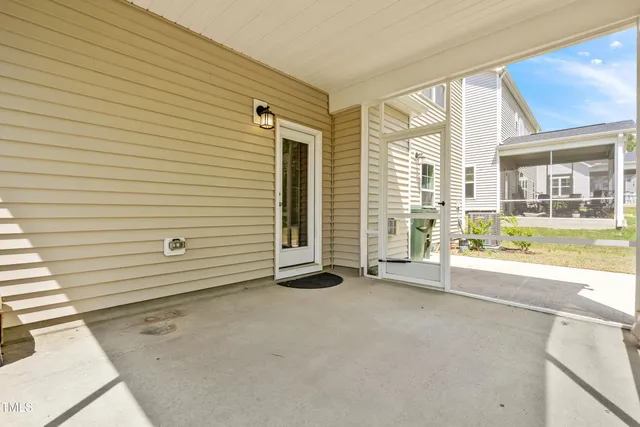 a view of a house with yard and sitting area