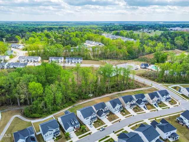 a view of a house with a yard and potted plants