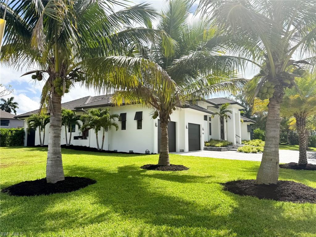 1702 Ludlow Road Marco Island, FL 34145 - Photo 5 of 47 Contemporary white stucco residence with a dark roofline