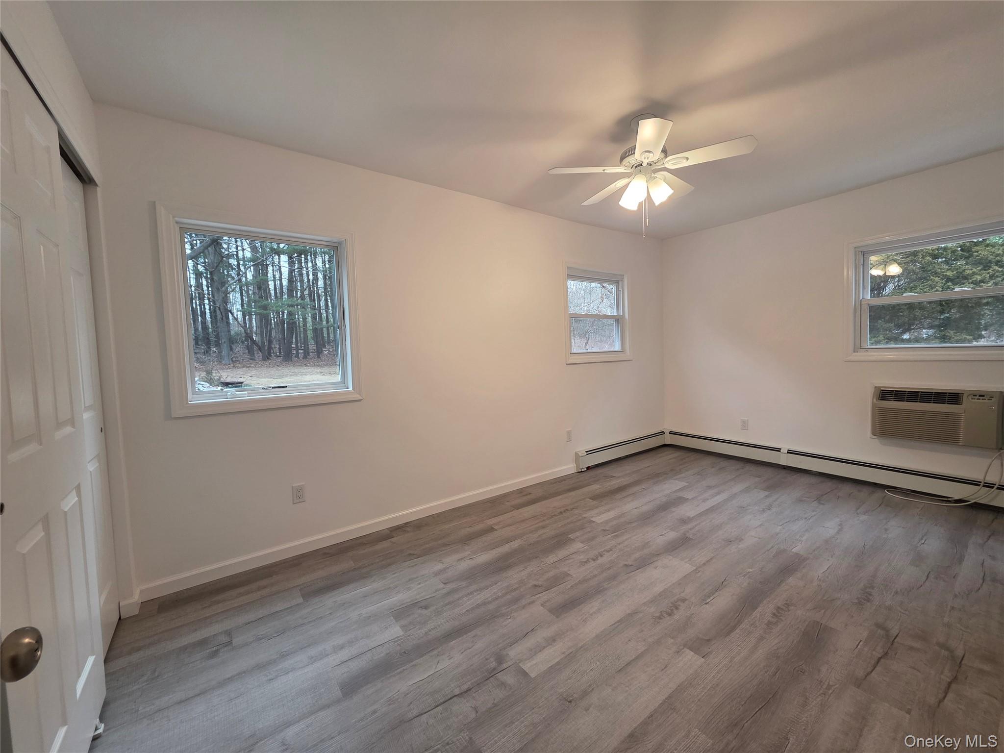 200 Deforest Road Dix Hills, NY 11746 - Photo 11 of 20 a view of an empty room with wooden floor and a window