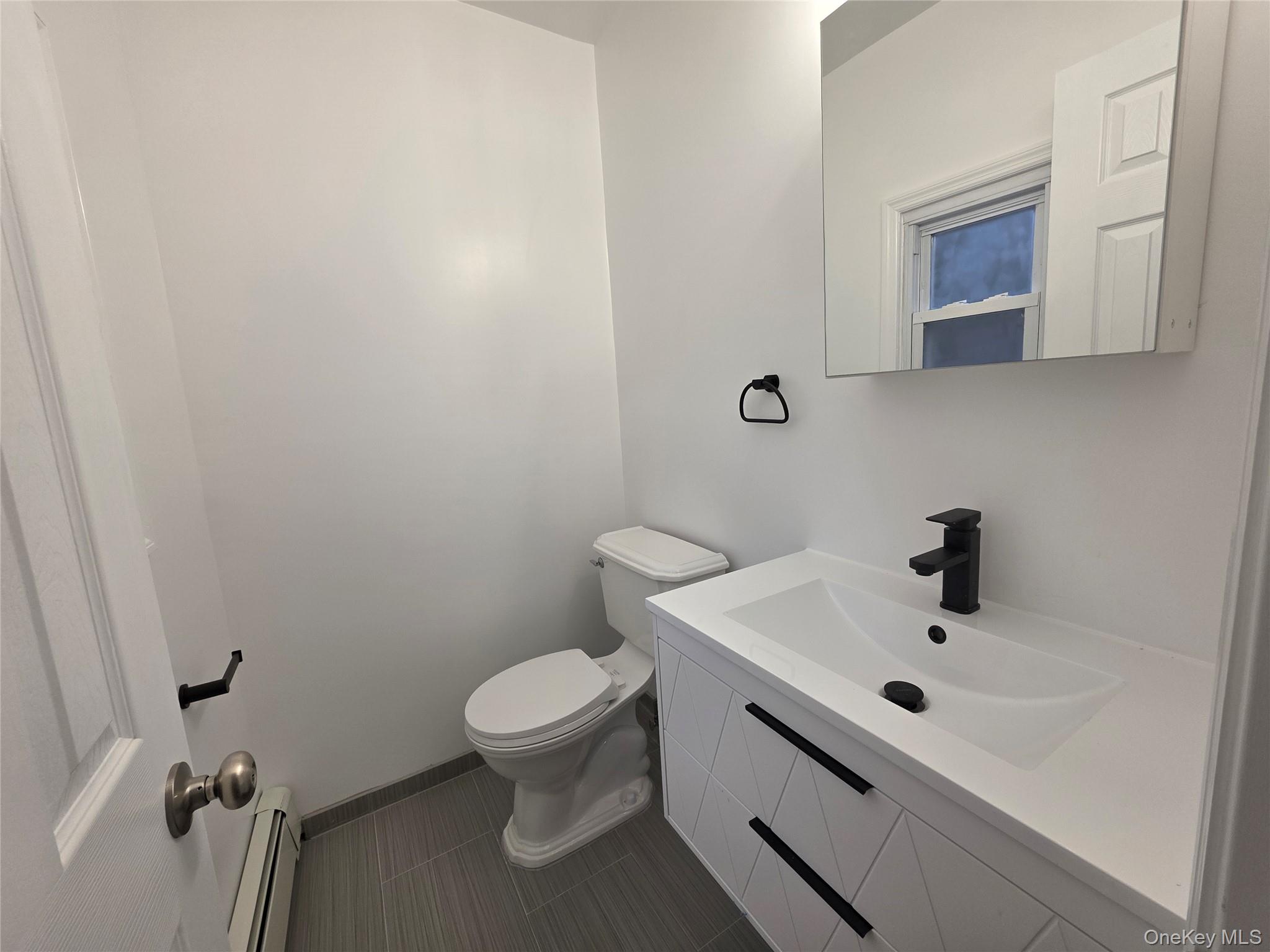 200 Deforest Road Dix Hills, NY 11746 - Photo 12 of 20 a bathroom with a sink mirror and toilet