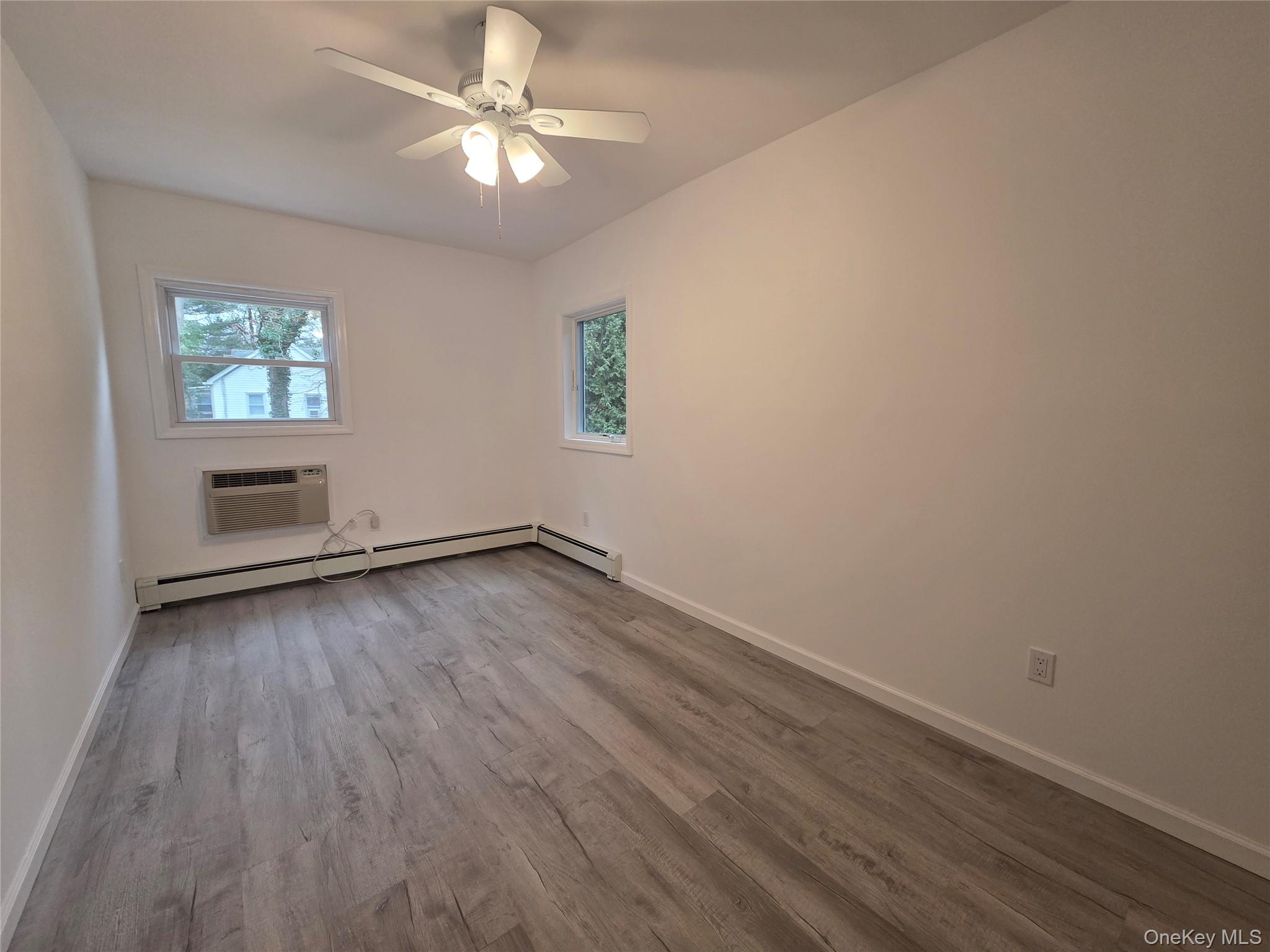 200 Deforest Road Dix Hills, NY 11746 - Photo 13 of 20 wooden floor in an empty room with a window