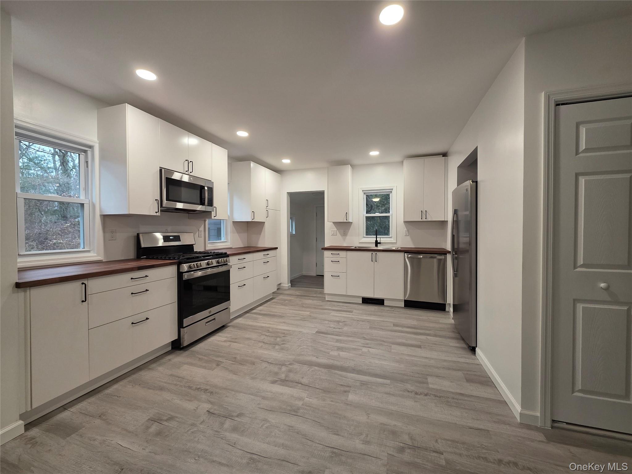 200 Deforest Road Dix Hills, NY 11746 - Photo 2 of 20 a large kitchen with cabinets and stainless steel appliances