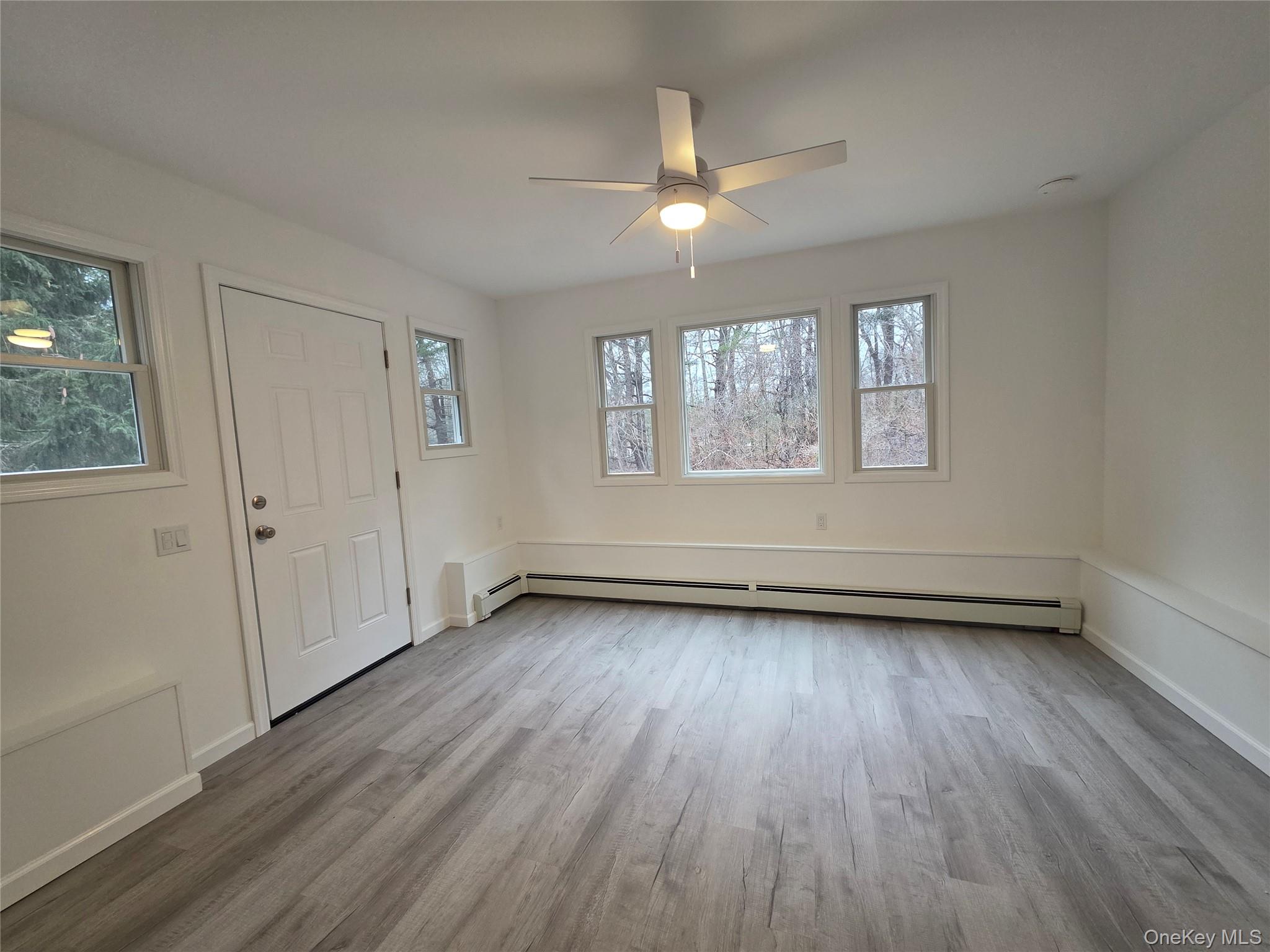 200 Deforest Road Dix Hills, NY 11746 - Photo 6 of 20 an empty room with wooden floor and windows
