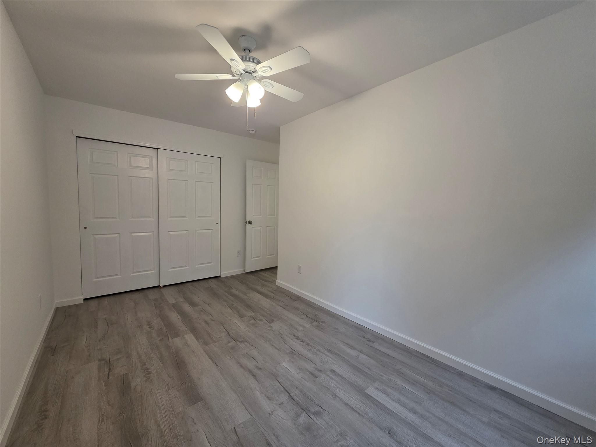 200 Deforest Road Dix Hills, NY 11746 - Photo 10 of 20 a view of an empty room with wooden floor