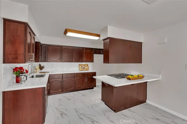 a kitchen with stainless steel appliances granite countertop a sink stove and wooden cabinets