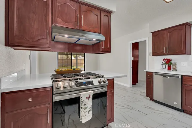 a kitchen with stainless steel appliances granite countertop a stove and a microwave