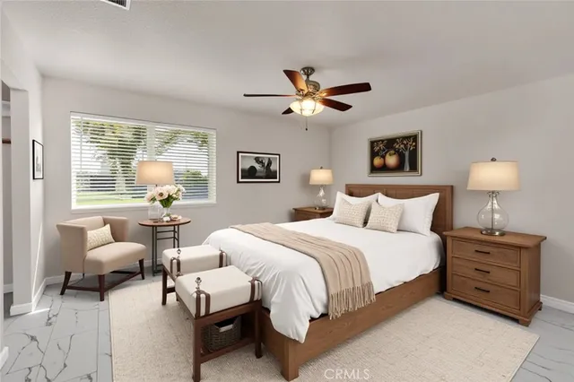 a bedroom with bed and a chandelier